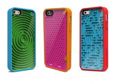 three cell phones with different colored cases on the same phone case, one has a maze design