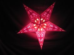 a red lighted star hanging from the ceiling