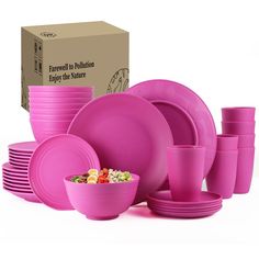 a pink dinnerware set in front of a cardboard box