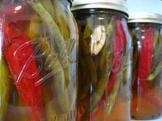 pickles and peppers are in mason jars on the counter, ready to be cooked