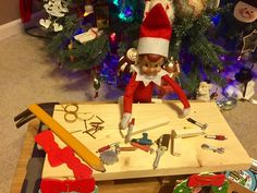 an elf is sitting at a table with tools