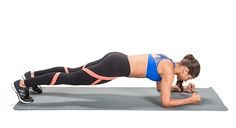 a woman doing push ups on a yoga mat