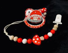 a red and white necklace with an elephant on it