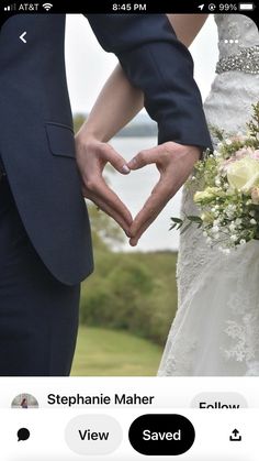 two people making a heart shape with their hands while holding each other's hands