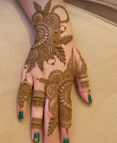 a woman's hand with henna on it