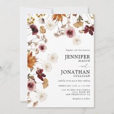 an elegant floral wedding card with white and red flowers on the front, in gold foil