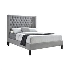 an upholstered bed with tufted headboard and foot board in grey fabric