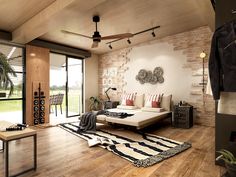 a living room filled with furniture and a brick wall next to a sliding glass door