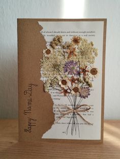 a greeting card with dried flowers on it