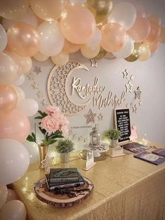 a table topped with books and balloons