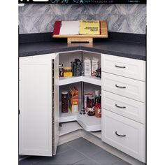 an open cabinet in the corner of a kitchen