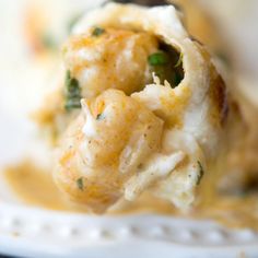 a close up of food on a fork with broccoli and cheese in it