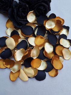 some black and gold flowers on a white table