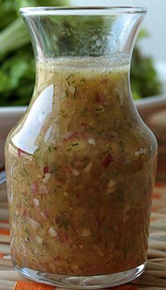 a glass jar filled with food sitting on top of a table next to a bowl