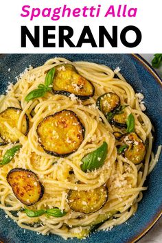 spaghetti with zucchini and parmesan cheese in a blue bowl on a white table