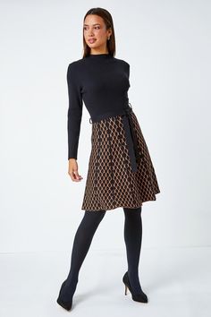 Contrast Skirt Knit Jacquard Dress from Roman. Perfect for the cooler season ahead, this contrast knit dress is crafted from a soft ribbed fabric. It features a cosy high neckline and long sleeves for a trendy finish. This dress is designed with a panelled, printed skirt which falls to an everyday knee-length in a flattering fit and flare style. Finished with a self-tie fabric belt, this is perfect paired with tights, boots and a fluffy gilet for an everyday Autumn look! Chic Fitted Pointelle Knit Skirt, Stretch Mini Dress With Lined Skirt, Elegant Skirted Dresses For Fall, Black Winter Dress With Lined Skirt, Black Winter Dresses With Lined Skirt, Black Lined Winter Dress, Winter Black Dresses With Lined Skirt, Elegant Textured Knit Mini Dress, Fitted Knee-length Knit Skirt