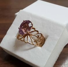 A mesmerizing one-of-a-kind treasure crafted from 10-karat yellow gold and embellished with a dazzling 3-carat amethyst (12 x 8mm). Delicately stamped with its designer's hallmark and "10k" insignia, this exquisite ring is in like-new condition - its bewitching beauty will elicit compliments every time you wear it! An ideal gift or keepsake to be treasured for a lifetime. Dimensions: 12x8mm Stone: Teardrop Amethyst Metal: Yellow 10k Gold BandWeight: 3.7 dwt. incl. stonesAmethyst Carat Weight: 3c Gold Amethyst Ring With Diamond Cut, Oval Shape, Fine Jewelry Amethyst Ring Stamped 14k As Gift, Fine Jewelry 14k Stamped Amethyst Ring Gift, Gold Oval Amethyst Ring With Diamond Cut, Fine Jewelry Amethyst Ring Stamped 14k For Gift, Gold Oval Amethyst Ring For Gift, Elegant 14k Stamped Amethyst Ring Gift, Oval Diamond Cut Yellow Gold Amethyst Ring, Oval Amethyst Ring In Yellow Gold With Diamond Cut