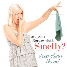 a woman holding up a green towel to her face with the caption, are your norwex cloths smellly? deep clean them