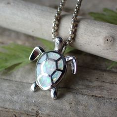 This is a very beautiful opal turtle charm. It measures 1/2” long from the top of the jump ring, 1/2" wide and is solid sterling silver with inlaid white lab created opal. T his charm is photographed on a 1 mm sterling silver rounded box chain which is sold separately. It can be found here. The turtle symbolizes many things. Most of us know the story of the tortoise and the hare, reminding us that slow and steady wins the race. The turtle also symbolizes the earth, staying grounded, wisdom and e White Sterling Silver Nature-inspired Jewelry, Nature-inspired White Sterling Silver Jewelry, Nature-inspired Sterling Silver Jewelry With Polished Finish, Nature-inspired Sterling Silver Jewelry, White Lab, Turtle Charm, Round Box, Turtle Necklace, Box Chain