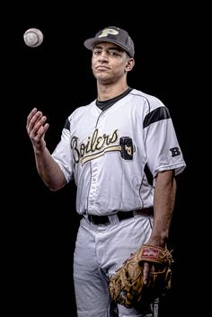 a baseball player holding a ball in his right hand and wearing a catchers mitt