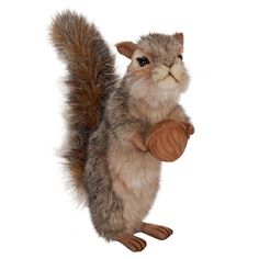 a stuffed squirrel holding an acorn on its hind legs and looking at the camera