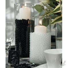 three candles are sitting in vases on a table