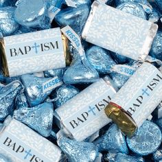 blue and white candies with the word badism printed on them in gold foil