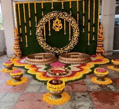 a decorated stage with candles and flowers on the floor