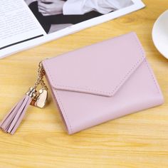 Brand Name: HEONYIRRYOrigin: CN(Origin)Lining Material: polyesterMaterial Composition: PU leatherMain Material: PUWallet Length: ShortItem Weight: 100gStyle: CasualModel Number: B406Item Width: 8.5 cmClosure Type: HaspItem Height: 2cmPattern Type: SolidInterior: Interior CompartmentInterior: Coin PocketInterior: Note CompartmentInterior: Photo HolderInterior: Card HolderGender: WOMENItem Length: 11.5cmItem Type: WalletWallets: Mini WalletsDecoration: TASSELProcessing mode: Soft surfaceEpidemic e Tassel Purse, Women's Wallets, Cute Wallets, Tassels Fashion, Wallets For Women Leather, Short Wallet, Purse Styles, Wholesale Bags, Card Bag