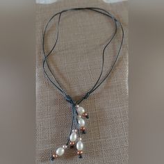 This Is A Handmade Pearl And Leather Necklace. I Bought It Brand New But It Has Never Been Worn. The Leather Is Handcrafted, Charcoal Grey And There Are White, Bronze And Light Pink Freshwater Pearls On It. The Necklace Can Be Worn 2 Ways And Is 9 1/2” Around The Neck And Ranges From 13”- 24” Long. Thanks For Looking! Black Beaded Pearl Necklaces With Pearl Pendant, Gray And White Pearl Necklace, Gray Pearl Necklace For Gift, Black Sterling Silver Pearl Necklace Gift, Black Pearl Leather Necklace, Black Pearl Jewelry, Rhodochrosite Necklace, Beautiful Gold Necklaces, Amulet Necklace