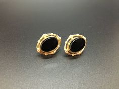 This is a classic and timeless set of earrings marked 12K Gold Filled with "CM" in the center of the screw back.  The setting is rich, gold-filled surrounding a polished black stone (perhaps onyx, perhaps glass) that has elegant beveled edges.  The stone has a smooth, mirror finish.  These earrings are in beautiful, vintage condition, measuring approximately 3/4" by 5/8" . Jeweled Bouquet, Black Stone Earrings, Frame Wreath, Screw Back Earrings, Black Stone, Vintage Frames, Stone Earrings, Lovely Gift, Gold Filled