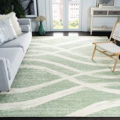 a living room filled with furniture and a green rug