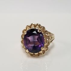 "Thanks for shopping our vintage estate store. We tend to sell well below wholesale and truly hope you enjoy all of our items. Many of the items are one of a kind, so please enjoy scrolling through the pictures and hopefully something will catch your eye. Brown spots are from camera or reflections. Estate 10k yellow gold purple blue 5ct sapphire cocktail filigree ring. Gem is testing natural, more than likely created, beautiful gem. Ring size: 5.5 Setting: 12mm 5/8\" Gem: 10mm by 12mm 5cts Band Estate Style Collectible Gemstone Jewelry, Estate Style 14k Gold Oval Jewelry, Estate Oval Jewelry For Gifts, Estate Style Round Jewelry Gift, Vintage 14k Stamped Amethyst Round Ring, Vintage 14k Stamped Amethyst Ring, Vintage Hallmarked Amethyst Ring For Collectors, Vintage Yellow Gold Amethyst Ring Gift, Vintage Gold Amethyst Birthstone Ring