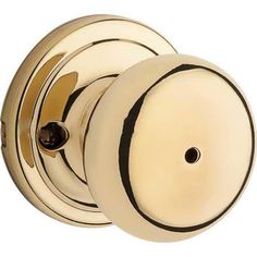 an antique brass door knob with black stripeing on the front and back sides, set in