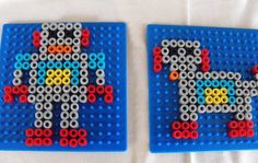 two legos made to look like they are playing with the same color beads on them