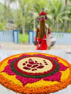 a woman standing in front of a flower arrangement