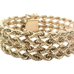 This exquisite gold bracelet features an intricate woven rope design, showcasing the craftsmanship and elegance of fine jewelry. Perfect for adding a touch of sophistication to any outfit. Elegant 14k Gold Rope Chain Bracelet, Elegant Braided Bracelet Jewelry, Elegant Braided Sterling Silver Bracelet, Formal 14k Gold Bracelets With Rope Chain, Elegant Gold Braided Jewelry, Elegant Formal Rope Chain Bracelet, Elegant Formal Gold Rope Chain Bracelet, Elegant Gold Rope Chain Bracelet For Formal Occasions, Rope Design