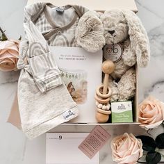 a baby gift box containing a teddy bear and other items