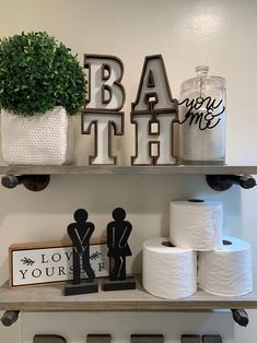 bathroom shelves with toilet paper and decorations on them