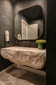 a bathroom sink sitting under a large mirror