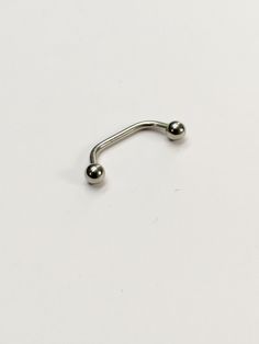 a metal nose ring with two balls on the end and one ball in the middle