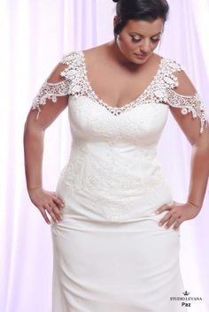 a woman in a white wedding dress with her hands on her hips