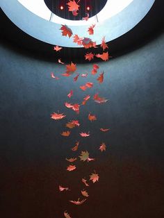 falling autumn leaves are suspended from the ceiling