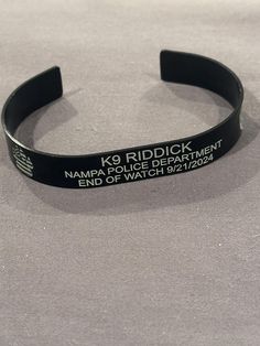 a black rubber bracelet with the words namir police department and end of watch on it