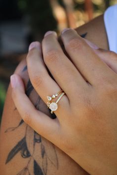 The Ava Moonstone Ring Set features a faceted, genuine 7mm round, genuine Rainbow Moonstone and white topaz accents on a pave band, paired with a curved stacking band. Gorgeous and classic, one to love for years to come. Also available made-to-order (3-4 weeks) in solid 14k gold. (Email to inquire) Available Metal Options: 14k Gold Vermeil, Rose Gold Vermeil and Sterling Silver. Gold Vermeil is a 2.5 micron thick layer of gold over a sterling silver base. Gemstons: Rainbow Moonstone, White Topaz Comes Ready to gift in a ring box. Moonstone Ring With Diamond Accents For Anniversary, Adjustable Round Moonstone Promise Ring, Adjustable Moonstone Ring With Accent Stones, Pave Band, Rainbow Moonstone Ring, Gold Ring Sets, Crystal Rose, Moonstone Ring, Topaz Ring