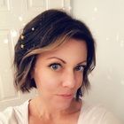 a woman is taking a selfie in front of a white wall with snow flakes