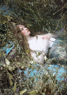 a woman laying down in the grass