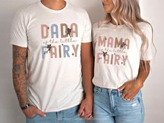 a man and woman standing next to each other wearing matching tshirts that read dad, the little fairy