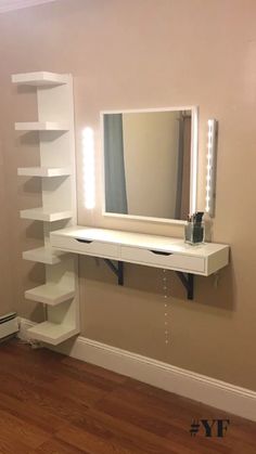 there is a white shelf with a mirror and lights on it in the corner of this room