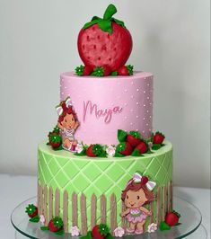 a three tiered cake with strawberry on top